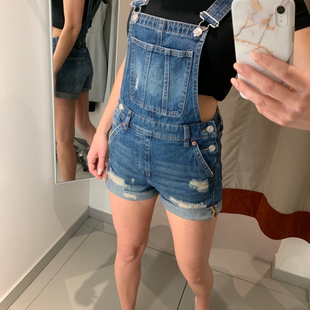 Distressed denim overalls